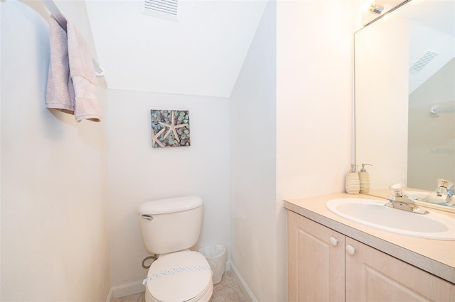 bathroom featuring visible vents, lofted ceiling, and vanity