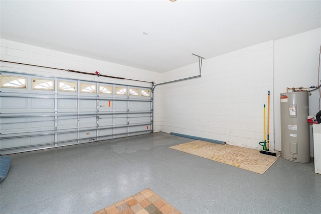 garage featuring concrete block wall and electric water heater