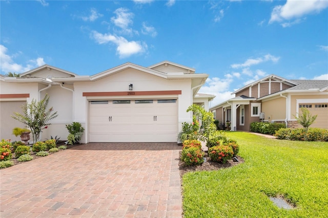 view of front of property with stucco siding, decorative driveway, an attached garage, and a front yard