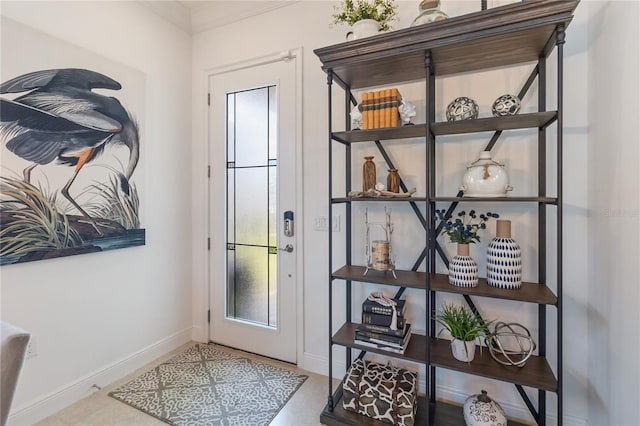 doorway to outside featuring baseboards
