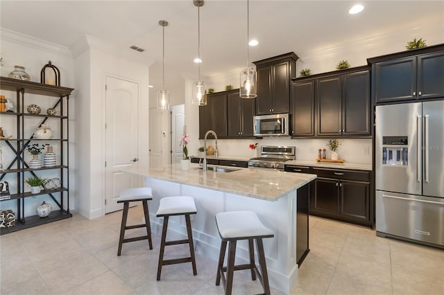kitchen with appliances with stainless steel finishes, light tile patterned floors, visible vents, and a sink