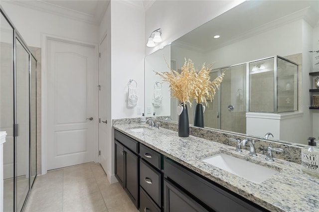bathroom with a stall shower, ornamental molding, and a sink