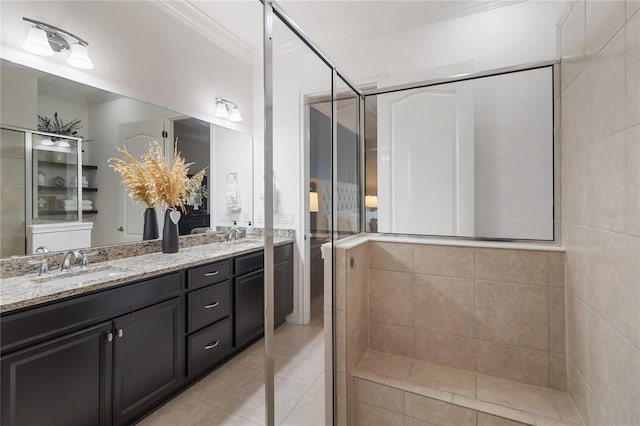 full bath featuring tile patterned floors, double vanity, a sink, a stall shower, and crown molding