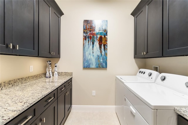 laundry room with light tile patterned floors, cabinet space, independent washer and dryer, and baseboards