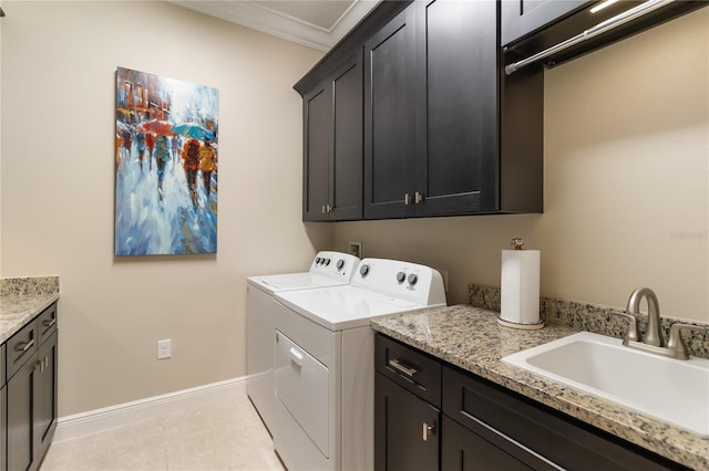 laundry area with a sink, cabinet space, independent washer and dryer, crown molding, and baseboards