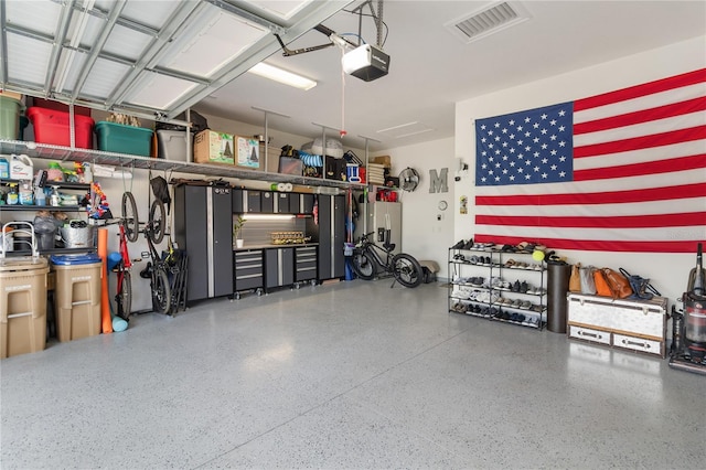 garage featuring a garage door opener and visible vents