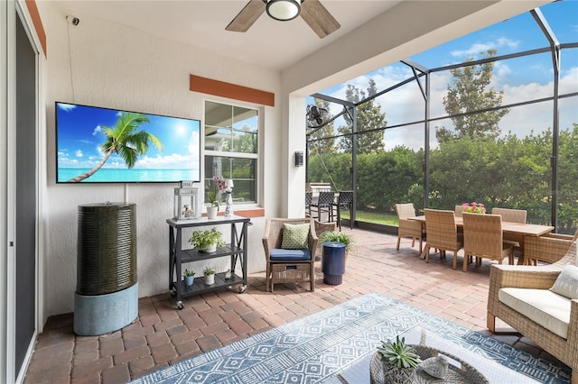 sunroom / solarium with outdoor dining space and ceiling fan