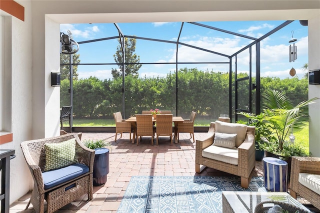 view of patio / terrace featuring a lanai, outdoor dining space, and an outdoor hangout area