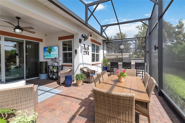 sunroom / solarium featuring outdoor dining space and a ceiling fan