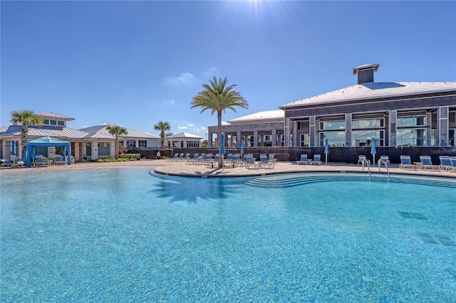 community pool featuring a patio, fence, and a gazebo