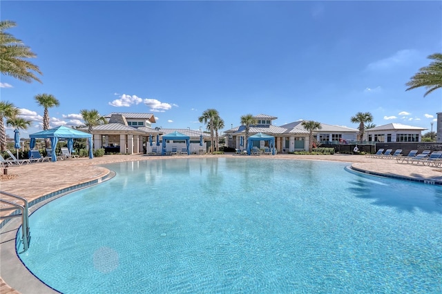 community pool featuring a gazebo and a patio
