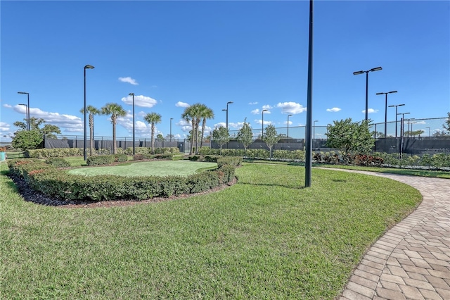view of home's community featuring fence and a yard