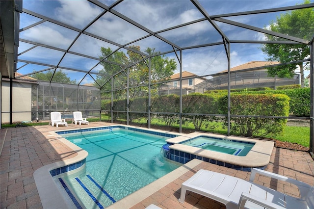 view of pool with a patio area and a pool with connected hot tub