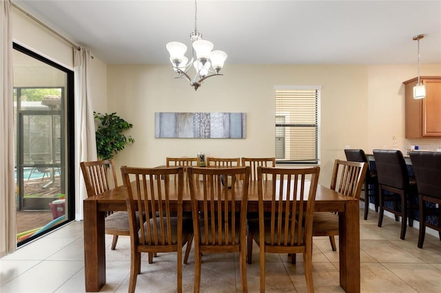 dining room with light tile patterned floors and a notable chandelier