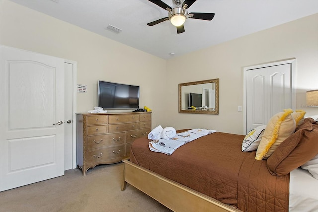 bedroom with visible vents, ceiling fan, and light colored carpet