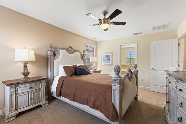 bedroom with visible vents, ceiling fan, baseboards, and light carpet