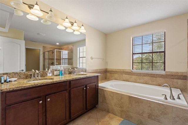 bathroom featuring a stall shower, a wealth of natural light, a bath, and a sink