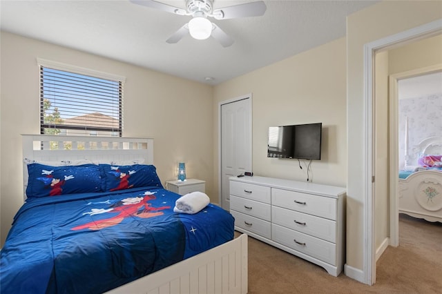 bedroom with baseboards, a ceiling fan, and light colored carpet