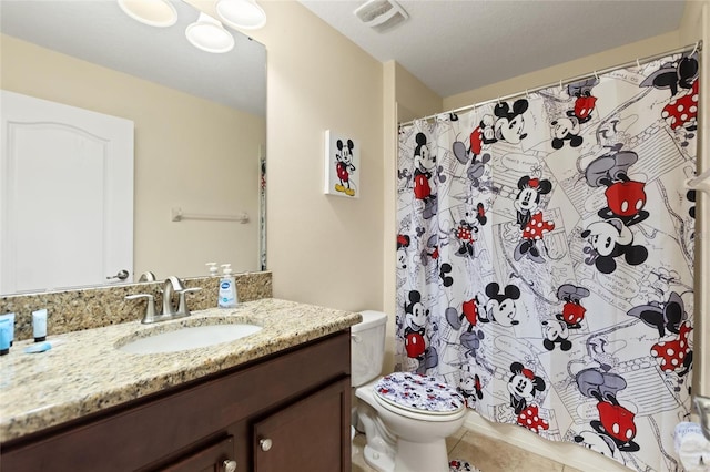 bathroom with tile patterned floors, toilet, curtained shower, vanity, and visible vents
