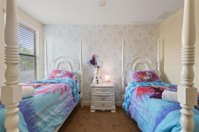 bedroom featuring ceiling fan, visible vents, baseboards, wallpapered walls, and carpet floors