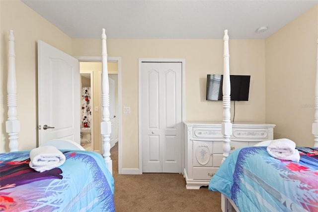 bedroom featuring a closet, baseboards, and carpet floors