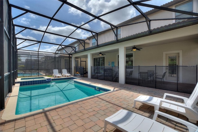 view of swimming pool with a lanai, a patio area, ceiling fan, and a pool with connected hot tub