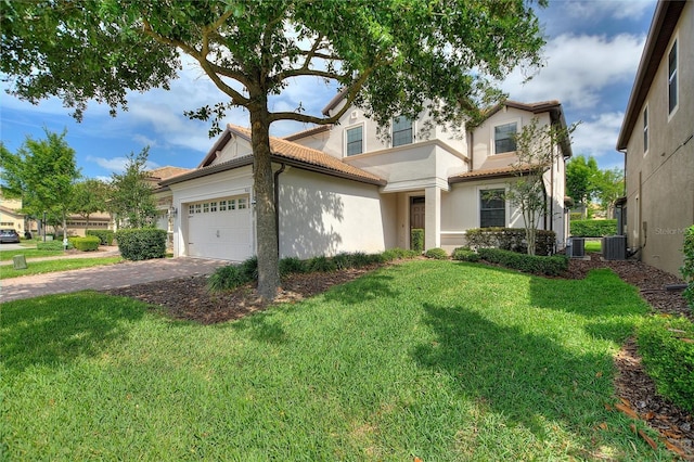 view of front facade with driveway, a tiled roof, an attached garage, and a front lawn