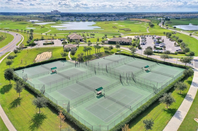 drone / aerial view with a water view and view of golf course