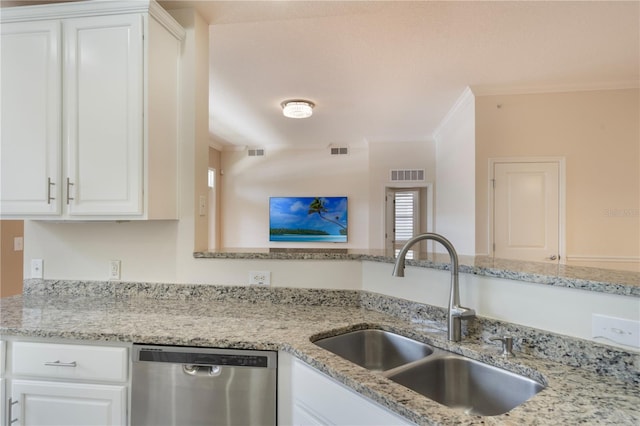 kitchen with visible vents, a sink, dishwasher, and white cabinets