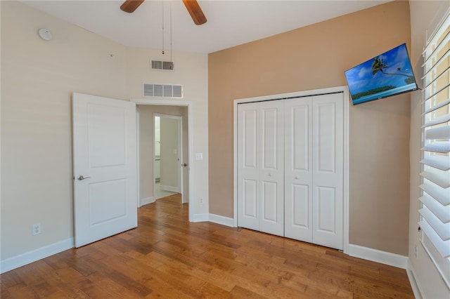 unfurnished bedroom with visible vents, baseboards, and wood finished floors