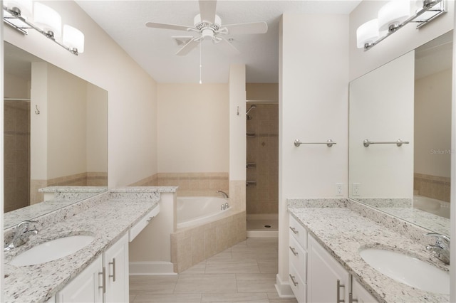 bathroom featuring a garden tub, a sink, a ceiling fan, and a shower stall