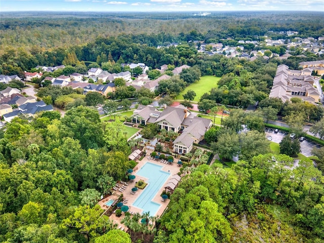 drone / aerial view with a residential view and a wooded view