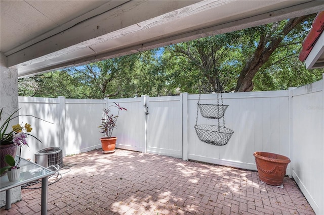 5077 Ernst Ct Unit 3, Orlando, FL 32819 - view of patio / terrace featuring a gate, a fenced backyard, and central AC unit