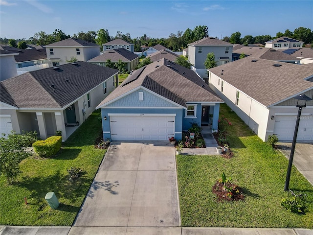 single story home with stucco siding, concrete driveway, an attached garage, and a residential view