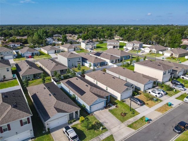 birds eye view of property featuring a residential view and a view of trees