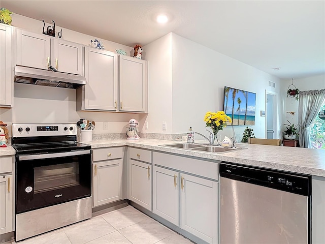 kitchen with a sink, appliances with stainless steel finishes, under cabinet range hood, and light countertops