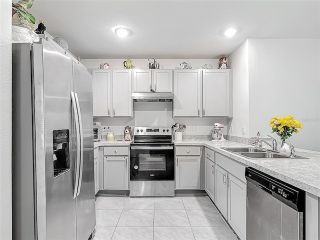 kitchen with range hood, a sink, stainless steel appliances, light tile patterned floors, and light countertops