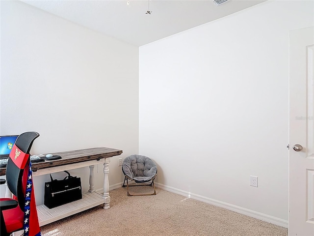 carpeted office space featuring baseboards