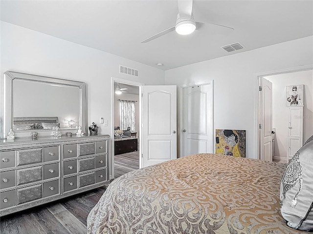 bedroom featuring ensuite bathroom, visible vents, a ceiling fan, and dark wood-type flooring
