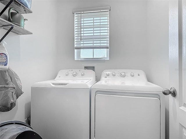 clothes washing area featuring independent washer and dryer and laundry area