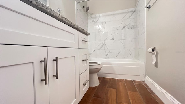 full bath with shower / bathing tub combination, wood finished floors, toilet, and baseboards