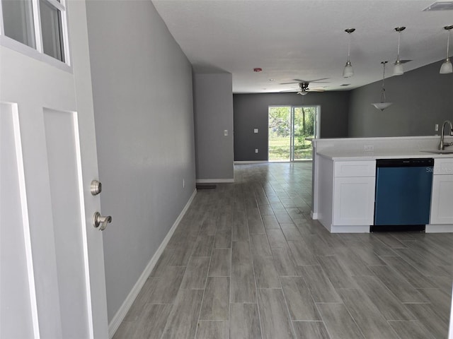 346 NW 24th Ave, Ocala, FL 34475 - kitchen with dishwashing machine, light wood-type flooring, white cabinetry, and a sink