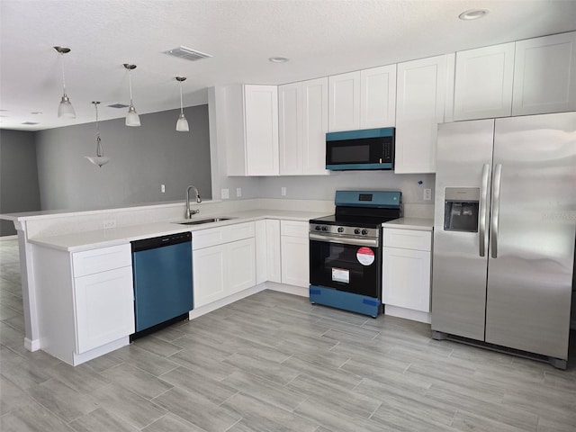 346 NW 24th Ave, Ocala, FL 34475 - kitchen featuring white cabinetry, a sink, appliances with stainless steel finishes, visible vents, and a peninsula