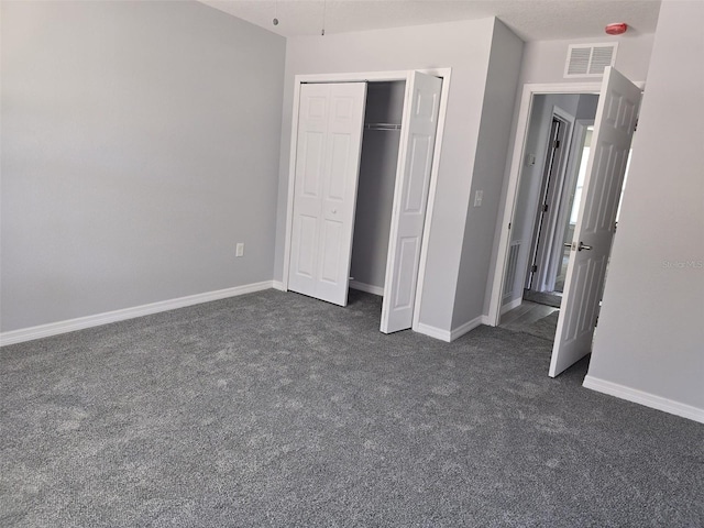 346 NW 24th Ave, Ocala, FL 34475 - unfurnished bedroom with a closet, visible vents, dark colored carpet, and baseboards