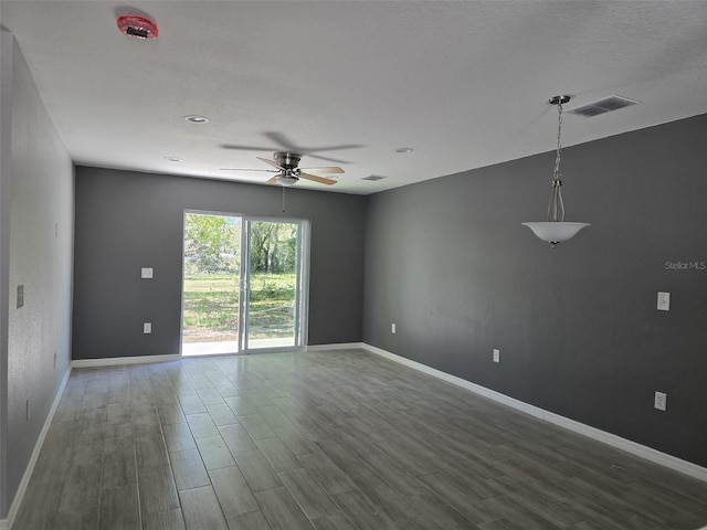346 NW 24th Ave, Ocala, FL 34475 - empty room featuring a ceiling fan, visible vents, baseboards, and dark wood finished floors
