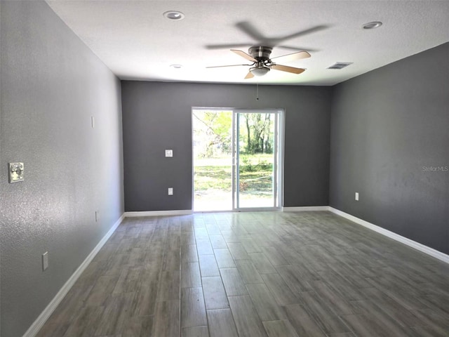 346 NW 24th Ave, Ocala, FL 34475 - spare room featuring dark wood-type flooring, visible vents, ceiling fan, and baseboards