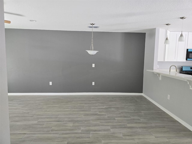 346 NW 24th Ave, Ocala, FL 34475 - kitchen featuring white cabinetry, range, visible vents, light countertops, and baseboards