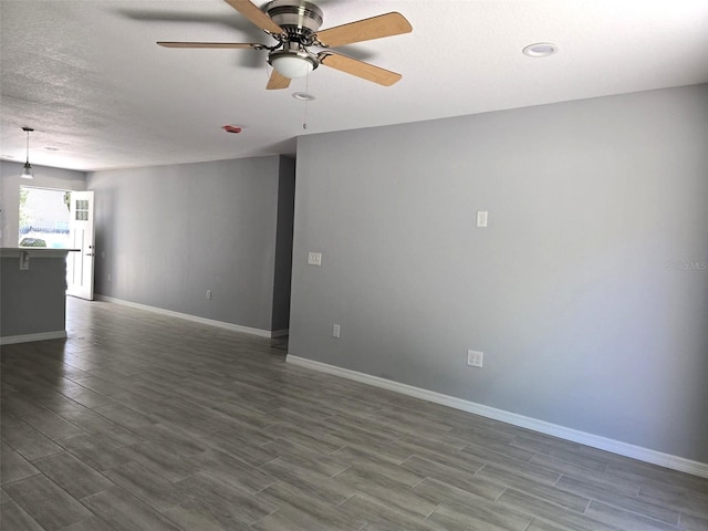 346 NW 24th Ave, Ocala, FL 34475 - unfurnished room featuring a ceiling fan, baseboards, a textured ceiling, and dark wood-type flooring