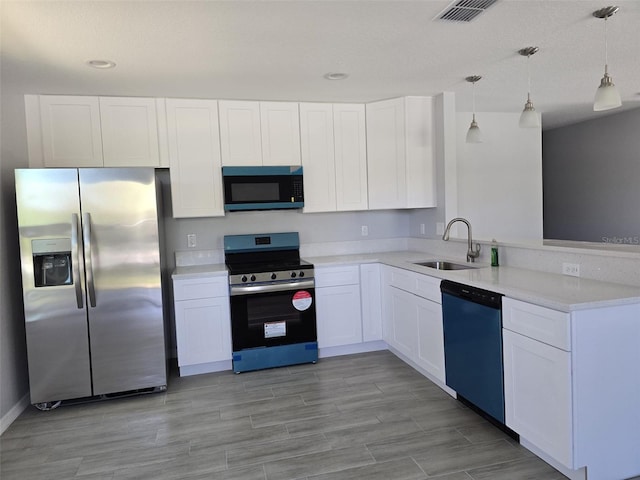 346 NW 24th Ave, Ocala, FL 34475 - kitchen featuring white cabinets, a sink, visible vents, stainless steel appliances, and a peninsula