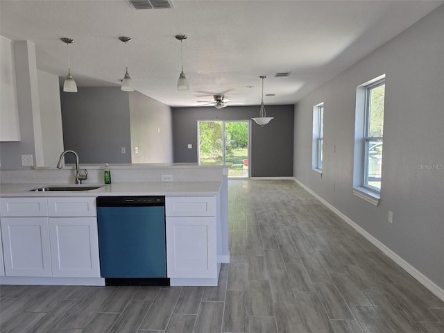 346 NW 24th Ave, Ocala, FL 34475 - kitchen with white cabinets, a sink, light countertops, dishwasher, and a peninsula